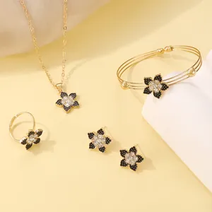 Detailed set of jewelry showing black floral necklace, bracelet, ring and earrings