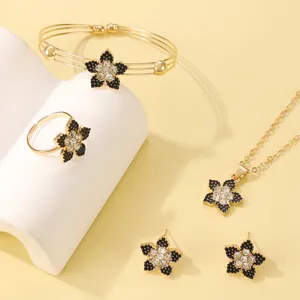 Elegant gold flower jewelry set with black rhinestones including necklace and bracelet