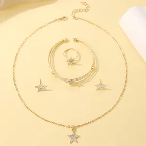 Detail of gold star jewelry set with necklace bracelet ring and earrings with crystals