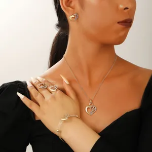 Macro shot of woman wearing elegant emerald cubic zirconia heart jewelry set for parties