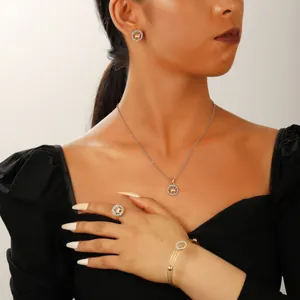 Detailed view of emerald green jewelry set with zircon crown design on a model