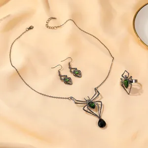 Gothic spider jewelry set with green gemstones including necklace, earrings and ring
