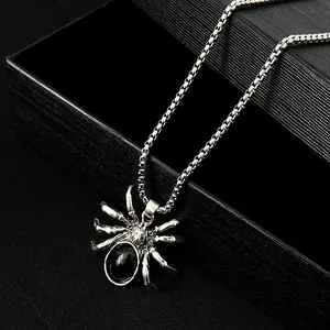 Macro shot of gothic spider necklace with black gemstone on a box chain for Halloween
