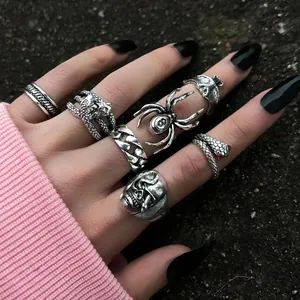 Close-up of gothic spider, snake and skull vintage rings worn on hand for Halloween styling