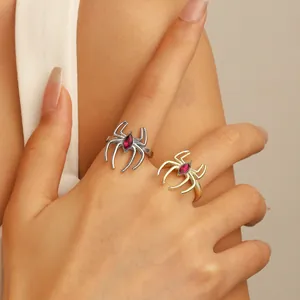 Detail of gothic spider rings in gold and silver finish with marquise red gemstones
