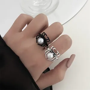Gothic spider rings detail with black and silver finishes and pearl center decorations