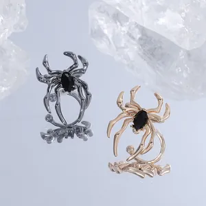 Detailed macro of spider jewelry set with marquise black gemstones in gunmetal and gold finish