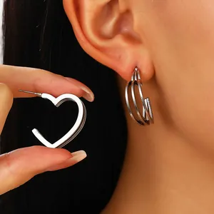 Detailed view of silver layered hollow heart earrings showing thickness and needle detail