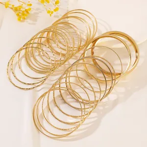 Ethnic style gold alloy bangle set with hammered and polished finishes for layered wear