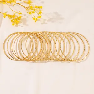 Detailed macro view of stacked gold textured and polished bangles in a luxury set