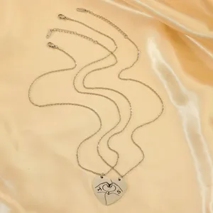 Detailed view of silver heart-shaped split pendant necklaces on premium silk