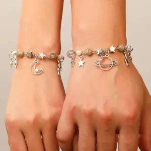 Silver charm bracelet featuring star moon and planet pendants with pearl beads for women