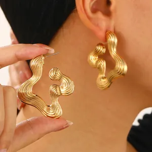 Elegant irregular gold wavy earrings with brushed metal texture for a luxury look