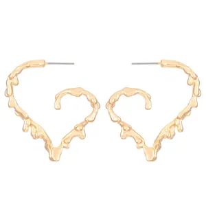 Elegant gold molten heart stud earrings with minimalist liquid metal design on white background