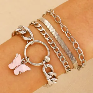 Detail of silver alloy bracelet set with pink butterfly charm and punk style chains
