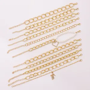 Detailed flat lay of 13 gold alloy bracelets with heart pendant and pearl accents