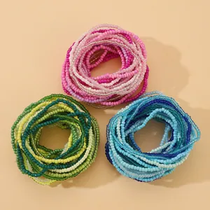 Close-up of handmade gradient seed bead elastic bracelets in pink, green and blue sets