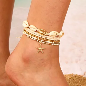 Tobillera bohemia de varias capas con estrella de mar dorada y colgante de concha