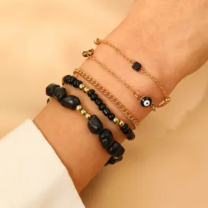 Juego de 4 pulseras apilables en negro y oro con amuleto de ojo turco para mujer