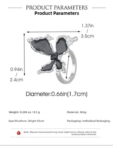 Detailed view of black enamel butterfly ring with liquid metal style silver frame