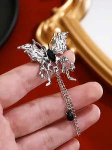 Close-up of gothic liquid lava butterfly ring with black stone and dangling chain detail