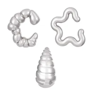 Three-piece set of silver metallic ear cuffs including star and spiral designs