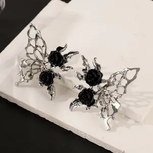 Gothic black rose and hollow silver butterfly stud earrings for women on white stone base