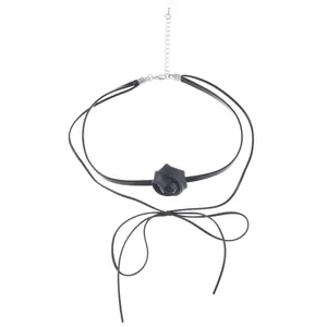 Detail of a black PU leather rose choker necklace with thin cords and ribbon bow ties