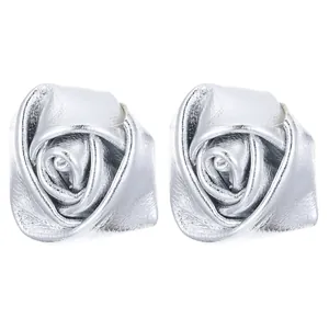 Silver 3D faux leather rose flower earrings with metallic texture on white background