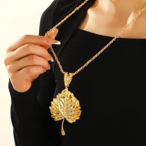 Golden poplar leaf pendant necklace with rhinestones on a thick gold twisted rope chain