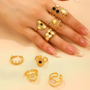 Detailed view of vintage gold rings featuring evil eye, moon and crown motifs on satin