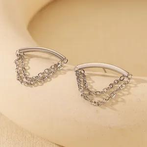Detail of silver stainless steel earring featuring triple chain tassel and curved bar