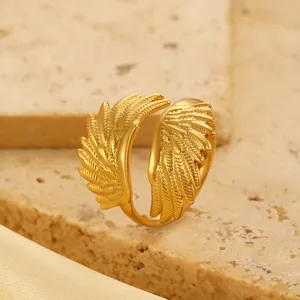 Macro detail of golden hollow feather wing ring with adjustable open band design