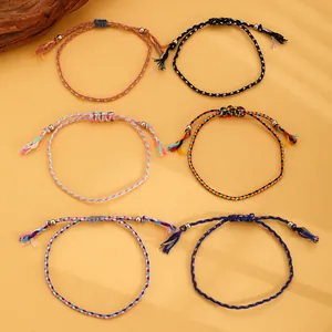 Detailed view of six handmade bohemian braided bracelets with adjustable sliding knots