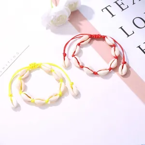 Handmade woven cowrie shell bracelets in red and yellow for bohemian beach style