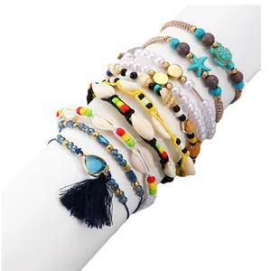 Bohemian multilayer bracelet set featuring colorful beads, turtle, starfish and blue tassel