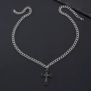 Macro view of retro gothic cross pendant with black crystals and flat cuban chain link