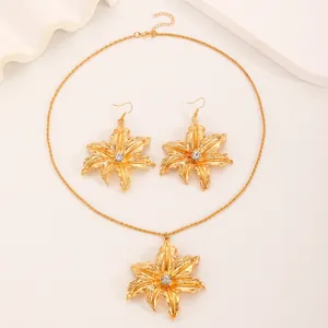Elegant gold-tone lily flower jewelry set with sparkling rhinestones and pendant earrings