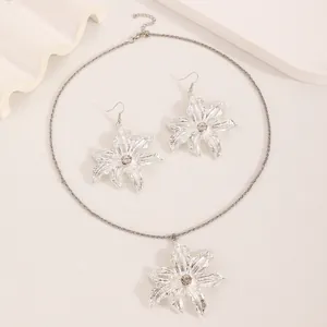 Silver lily floral pendant necklace and earrings set with sparkling diamond accents