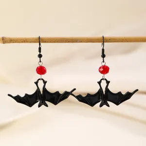 Gothic Halloween bat drop earrings with red bead accent and black metal hooks