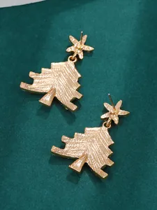 Macro shot showing the gold-plated back texture and needle detail of Christmas tree earrings