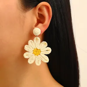Bohemian raffia sunflower earrings in classic white and yellow woven floral design