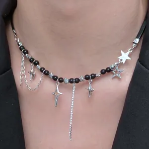 Close-up of Y2K star pendant necklace with black beads and rhinestone tassel details