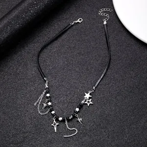 Detail of Y2K leather choker with silver stars, crystal number 5, and metallic tassels
