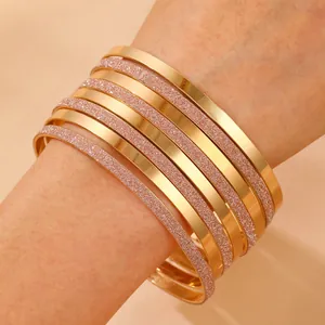 12-piece stackable gold alloy bangles set with mixed polished and glitter finishes