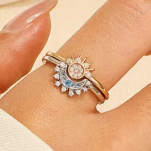 Elegant sun and moon nesting rings with diamonds and blue gemstones on gold and silver bands