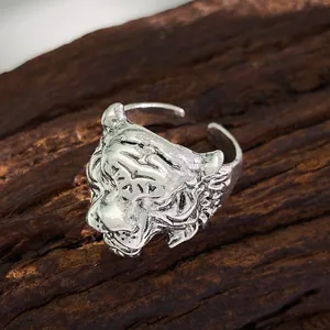 Vintage silver tiger head open ring for men featuring detailed animal carving on wood