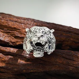 Macro shot of the detailed vintage silver tiger head ring showing intricate textures