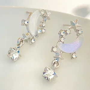 Elegant star and moon stud earrings in silver with shimmering opal moon and star pendants