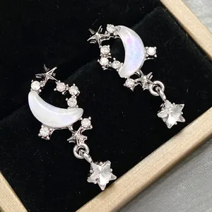 Elegant silver star and moon earrings with purple opal inlay and sparkling zircons